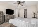 Relaxing bedroom featuring a plush bed, dresser, ceiling fan, and a window for natural light at 5539 S Verde --, Mesa, AZ 85212