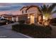 Inviting front exterior showcasing desert landscaping, stone accents, and a covered entrance at 5539 S Verde --, Mesa, AZ 85212