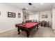 Open game room features a red felt pool table and is open to the foosball and dining areas at 5539 S Verde --, Mesa, AZ 85212