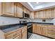 Spacious kitchen featuring wood cabinetry, stainless steel appliances, and tile flooring at 592 Leisure World --, Mesa, AZ 85206