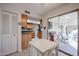 Bright kitchen featuring tile floors, adjacent dining area, outdoor patio, and wood cabinets at 592 Leisure World --, Mesa, AZ 85206