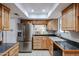 Kitchen with wood cabinets, granite countertops, stainless steel fridge and a view to another room at 592 Leisure World --, Mesa, AZ 85206