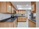 Well-lit kitchen with wooden cabinets, stainless steel appliances, and tiled floors at 592 Leisure World --, Mesa, AZ 85206