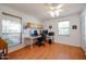 Bright home office with a large desk, overhead cabinets, and plank flooring at 592 Leisure World --, Mesa, AZ 85206