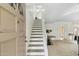 Bright entryway with a staircase leading to the upper level and beautiful glass paneled front door at 6009 N 79Th St, Scottsdale, AZ 85250