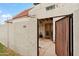 The private front patio has an entry gate, flagstone flooring, neutral stucco walls, and a shaded ceiling at 6009 N 79Th St, Scottsdale, AZ 85250