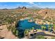 Stunning aerial view of the community lake with palm trees and desert mountain views at 6121 E Vernon Ave, Scottsdale, AZ 85257
