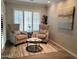 Charming living room nook with comfortable armchairs, stylish rug, and bright natural light at 6121 E Vernon Ave, Scottsdale, AZ 85257