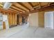 Unfinished basement with exposed wood framing and concrete floor at 625 W Central Ave, Coolidge, AZ 85128