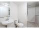 Compact bathroom featuring a pedestal sink, toilet, and shower, maximizing functionality in a minimal space at 625 W Central Ave, Coolidge, AZ 85128