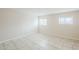 Bright bedroom with tile flooring and two windows providing natural light at 625 W Central Ave, Coolidge, AZ 85128