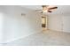 Tile-floored bedroom features white walls and a ceiling fan with light fixture at 625 W Central Ave, Coolidge, AZ 85128