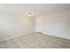 Bedroom with neutral walls, tile flooring, and a white door at 625 W Central Ave, Coolidge, AZ 85128