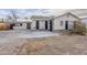 Charming single-story home featuring stucco exterior, black shutters, stone accents, and a spacious concrete driveway at 625 W Central Ave, Coolidge, AZ 85128