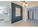 This kitchenette features sleek, white cabinetry, paired with tile floors, and an adjacent built-in shelving unit at 625 W Central Ave, Coolidge, AZ 85128