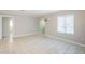 Well-lit living room with tile flooring, neutral paint, white trim, and large window for natural light at 625 W Central Ave, Coolidge, AZ 85128