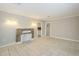 Open living area with tile flooring, stone fireplace, neutral paint, and doorways leading to other rooms at 625 W Central Ave, Coolidge, AZ 85128