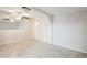 Open living room with tile flooring, ceiling fan, and a mirror, enhancing the sense of space and light at 625 W Central Ave, Coolidge, AZ 85128