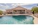 Relaxing backyard with a sparkling pool, covered patio, and desert landscaping at 6786 W Appaloosa Trl, Coolidge, AZ 85128