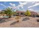 Beautiful backyard featuring a private pool, palm tree, desert landscaping, and covered patio with a grill at 6786 W Appaloosa Trl, Coolidge, AZ 85128