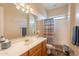 Well-lit bathroom featuring a single sink vanity, large mirror, and shower-tub combo at 6786 W Appaloosa Trl, Coolidge, AZ 85128