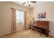 Bright bedroom featuring a piano, large window, and neutral carpet at 6786 W Appaloosa Trl, Coolidge, AZ 85128