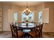 Cozy dining area with round table, bay windows, and elegant chandelier at 6786 W Appaloosa Trl, Coolidge, AZ 85128