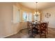 Charming dining area featuring a round table, shuttered windows and decorative lighting at 6786 W Appaloosa Trl, Coolidge, AZ 85128