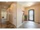 Welcoming entryway with decorative iron door, tile flooring and neutral color palette at 6786 W Appaloosa Trl, Coolidge, AZ 85128