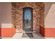 Close up of the front door showcasing the stone and the wrought iron door at 6786 W Appaloosa Trl, Coolidge, AZ 85128