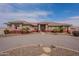 Single story stucco home featuring circular driveway and tiled roof at 6786 W Appaloosa Trl, Coolidge, AZ 85128