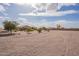 Spacious gravel front yard with desert landscaping leading to a charming single-story home at 6786 W Appaloosa Trl, Coolidge, AZ 85128