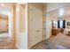 Inviting hallway showcasing tile flooring, built-in shelving, and access to a bedroom at 6786 W Appaloosa Trl, Coolidge, AZ 85128