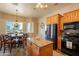 Kitchen boasting wood cabinetry, stainless steel appliances, granite counters, and adjacent dining area at 6786 W Appaloosa Trl, Coolidge, AZ 85128