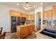 Kitchen featuring wooden cabinets, granite countertops, stainless steel appliances, and a center island at 6786 W Appaloosa Trl, Coolidge, AZ 85128