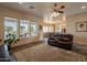 Open living room offers natural light from windows, with access to pool views and slate flooring at 6786 W Appaloosa Trl, Coolidge, AZ 85128