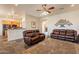 Inviting living room featuring slate floors, leather sofas, and decorous accent pieces at 6786 W Appaloosa Trl, Coolidge, AZ 85128