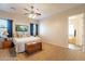 Cozy main bedroom featuring a ceiling fan, plush carpet, and an ensuite bathroom at 6786 W Appaloosa Trl, Coolidge, AZ 85128