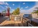 Outdoor kitchen area featuring a built-in grill, stone accents, and stainless steel storage drawers at 6786 W Appaloosa Trl, Coolidge, AZ 85128