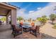 Inviting outdoor patio with comfortable seating area and fire pit, overlooking lush landscaping at 6786 W Appaloosa Trl, Coolidge, AZ 85128