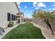 Beautiful backyard featuring artificial grass, a desert landscape, and a covered patio with furniture at 6890 W Remuda Dr, Peoria, AZ 85383