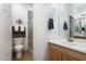 Neat bathroom with a pedestal sink, a toilet with brown towels, and a glass-walled shower at 6890 W Remuda Dr, Peoria, AZ 85383