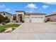 Charming single-story home with a well-manicured lawn and a three-car garage at 6890 W Remuda Dr, Peoria, AZ 85383