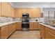 Well-equipped kitchen featuring light wood cabinets and stainless steel appliances at 6890 W Remuda Dr, Peoria, AZ 85383