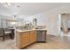 Stylish kitchen area with an adjacent sink, modern appliances, and open layout at 6890 W Remuda Dr, Peoria, AZ 85383