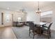 Bright living room with a dining area featuring neutral tones and natural light at 6890 W Remuda Dr, Peoria, AZ 85383