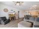 Cozy living room with rustic accents, a fireplace, and seamless kitchen access at 6890 W Remuda Dr, Peoria, AZ 85383