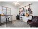 Modern home office setup with guitar decor, ceiling fan, desk, and stylish carpet at 6890 W Remuda Dr, Peoria, AZ 85383