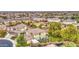 View of a house with neutral colors and tile roof in a neighborhood with lush landscaping at 7010 S San Jacinto Ct, Gilbert, AZ 85298