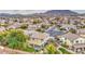 View of a home with neutral colors and tile roof in a neighborhood with desert landscaping at 7010 S San Jacinto Ct, Gilbert, AZ 85298